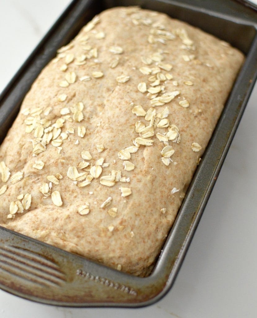 1 loaf of bread in a pan with oatmeal on top. 