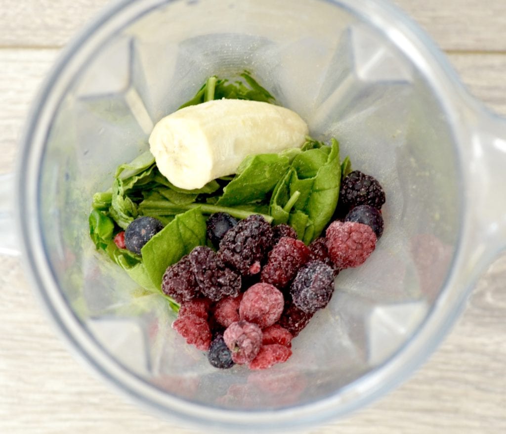 Overhead view of Berry Protein Smoothie ingredients in a vitamix before belnding