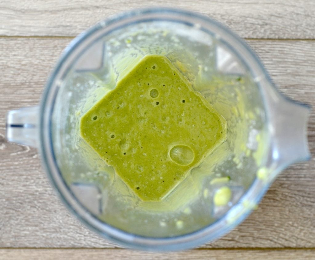 Overhead view of an open vitamix blender with the wet ingredients blended in the making of Zucchini Banana Pancakes Recipe