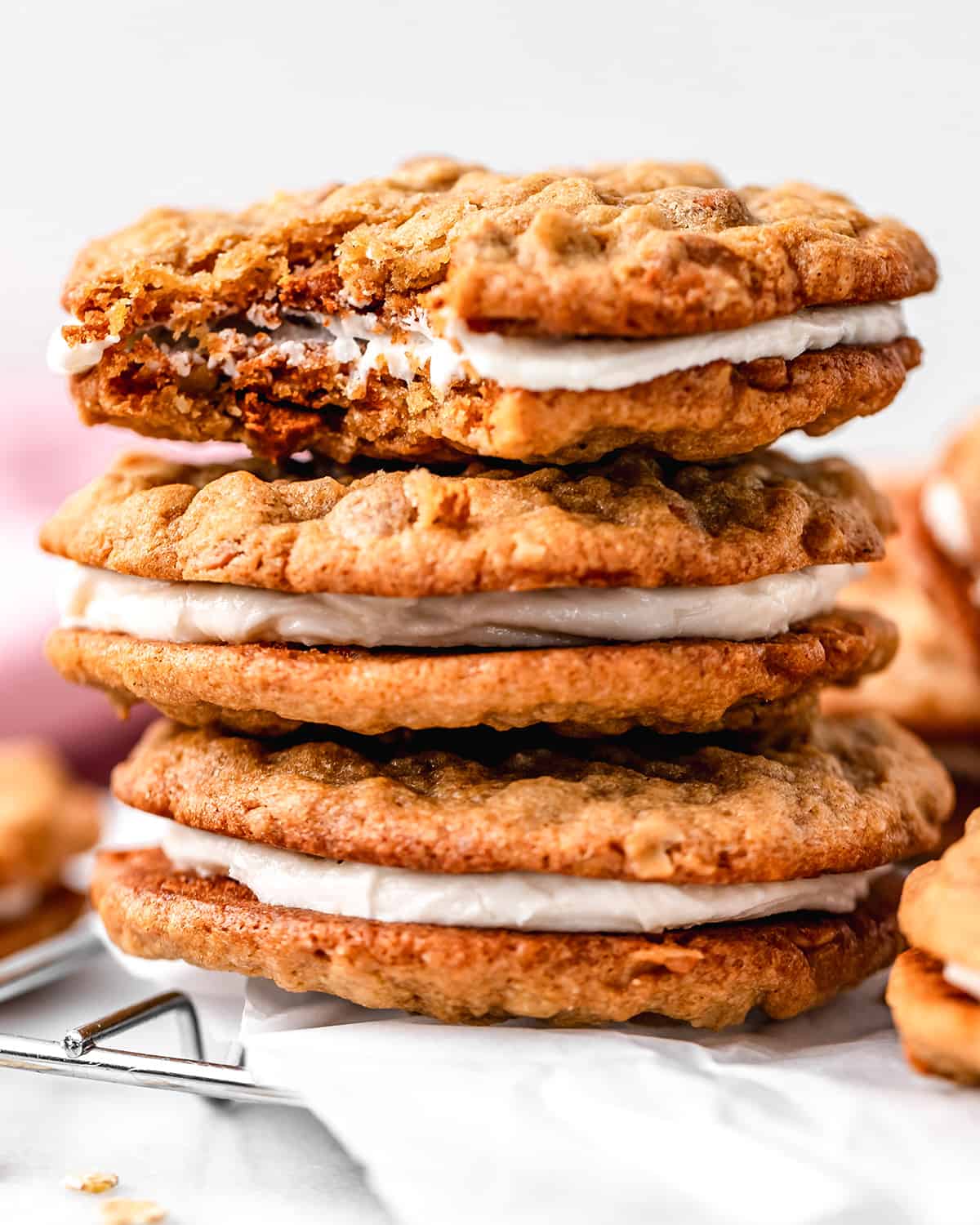 a stack of 3 Homemade Oatmeal Cream Pies, the top one with a bite taken out of it