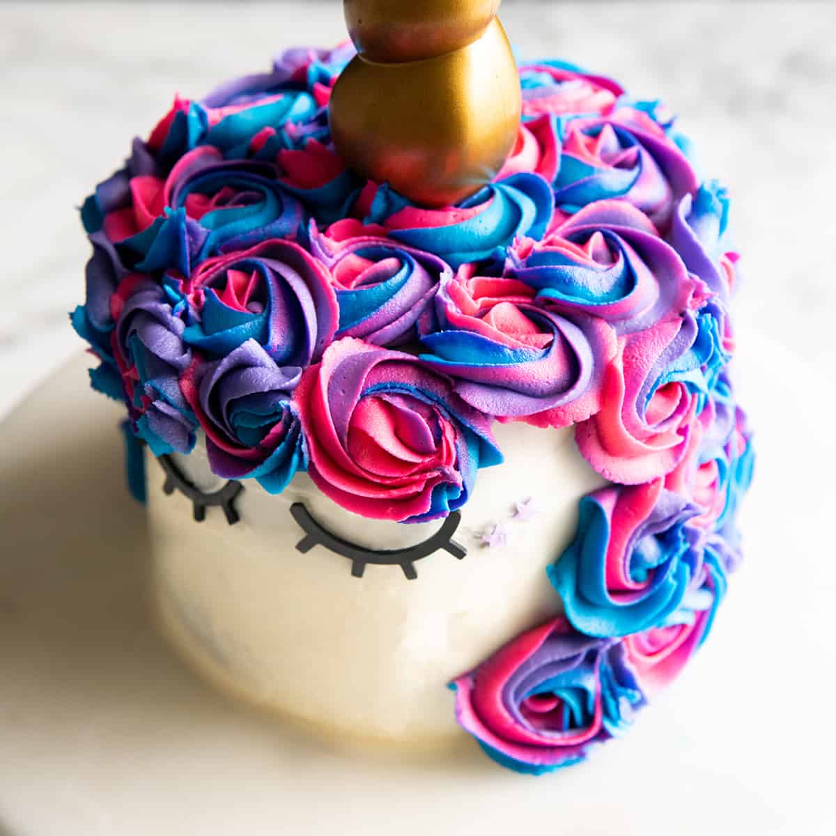 unicorn cake decorated with homemade vanilla frosting