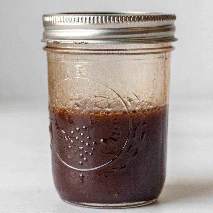 a glass jar with Maple Balsamic Vinaigrette Dressing inside