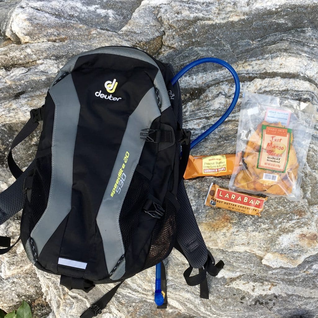 overhead view of a hydration pack and kids snacks in The Complete Guide to Hiking with Kids