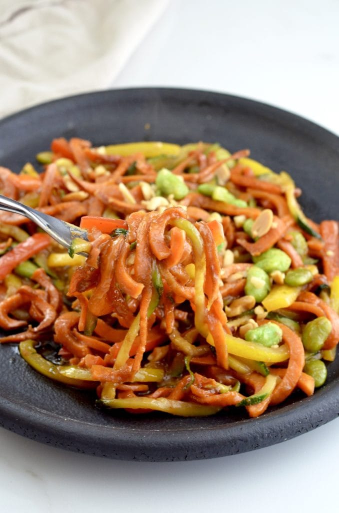 Front view of a fork twirling a bite of Spiralized Sweet Potato Stir Fry