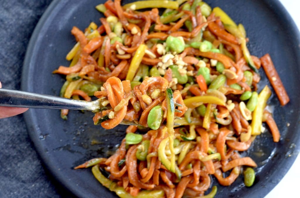 Overhead view of a fork twirling Spiralized Sweet Potato Stir Fry