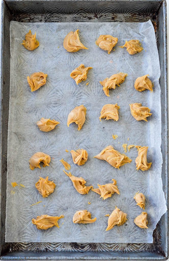 Overhead view of peanut butter chunks on a baking sheet lined with parchment paper ready to go into the freezer
