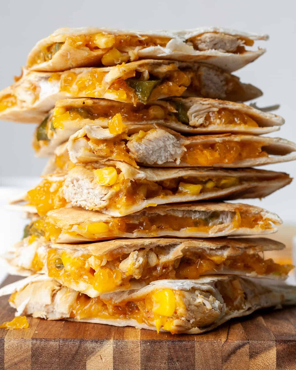 front view of a stack of 8 pieces of chicken quesadilla