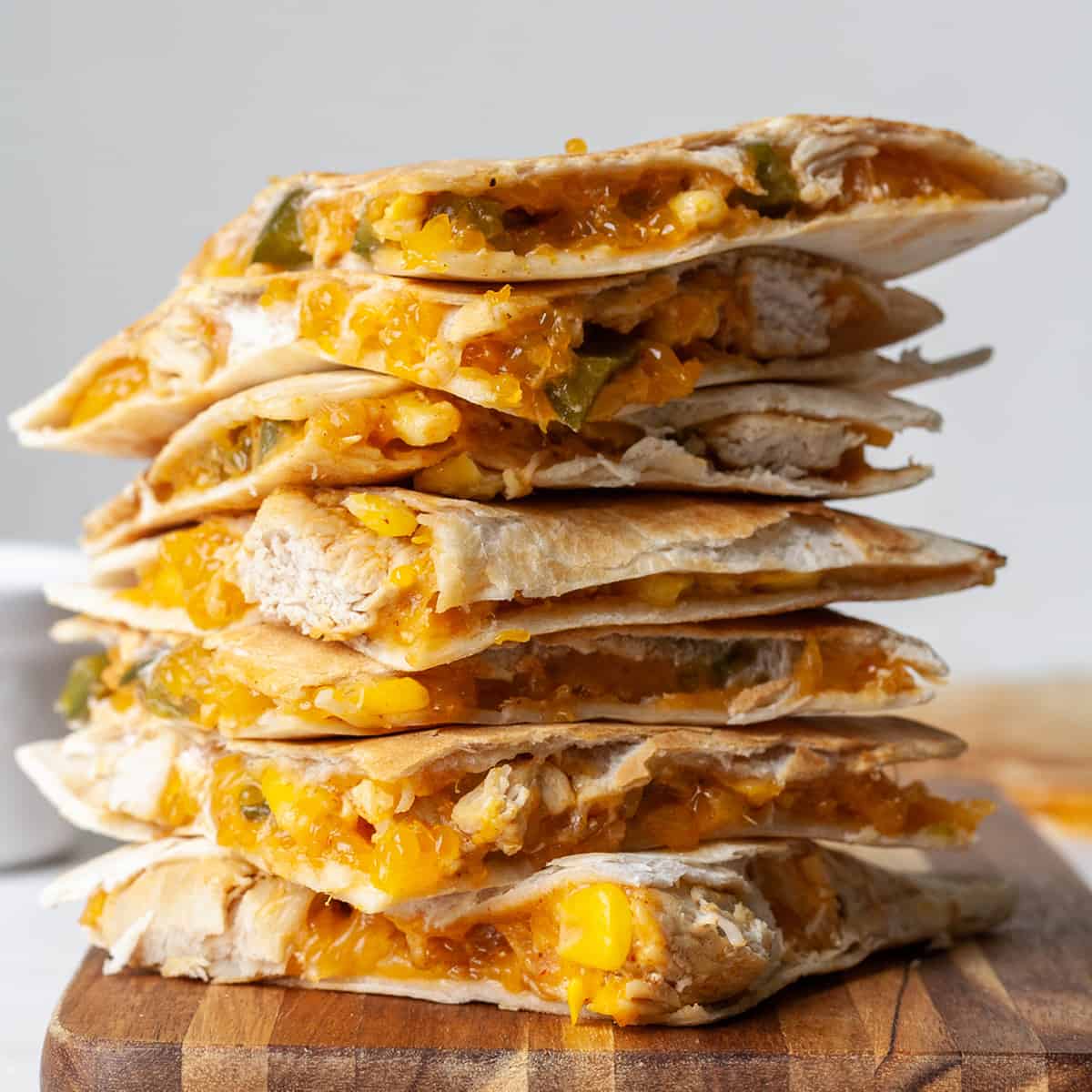 front view of a stack of 7 pieces of chicken quesadilla