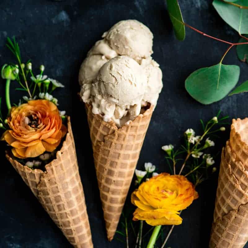 Overhead view of four scoops of Paleo Vanilla Ice Cream in a waffle cone