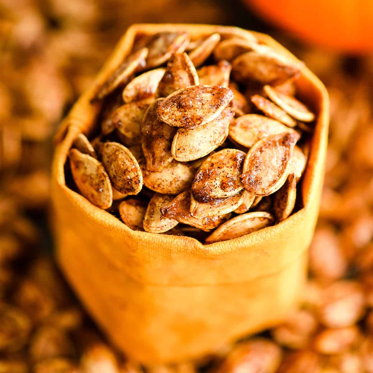 front view of cinnamon sugar pumpkin seeds in an orange storage bag