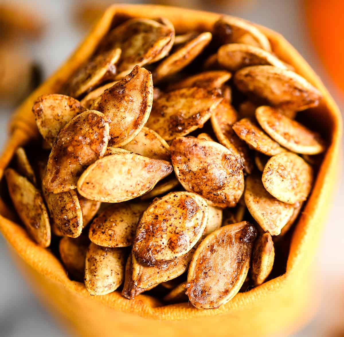 up close front view of Homemade Cinnamon Sugar Pumpkin Seeds in a small bag