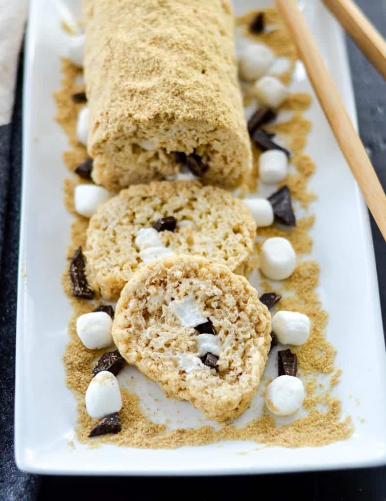 overhead view of a s'mores Dessert Sushi roll with two pieces cut