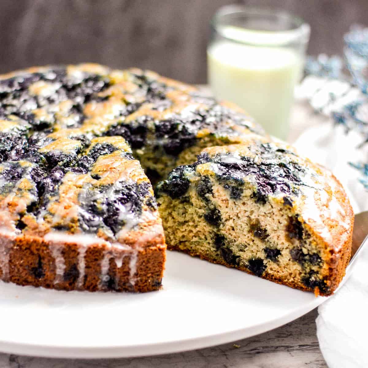 Dairy Free Blueberry Coffee Cake with a slice cut out of it