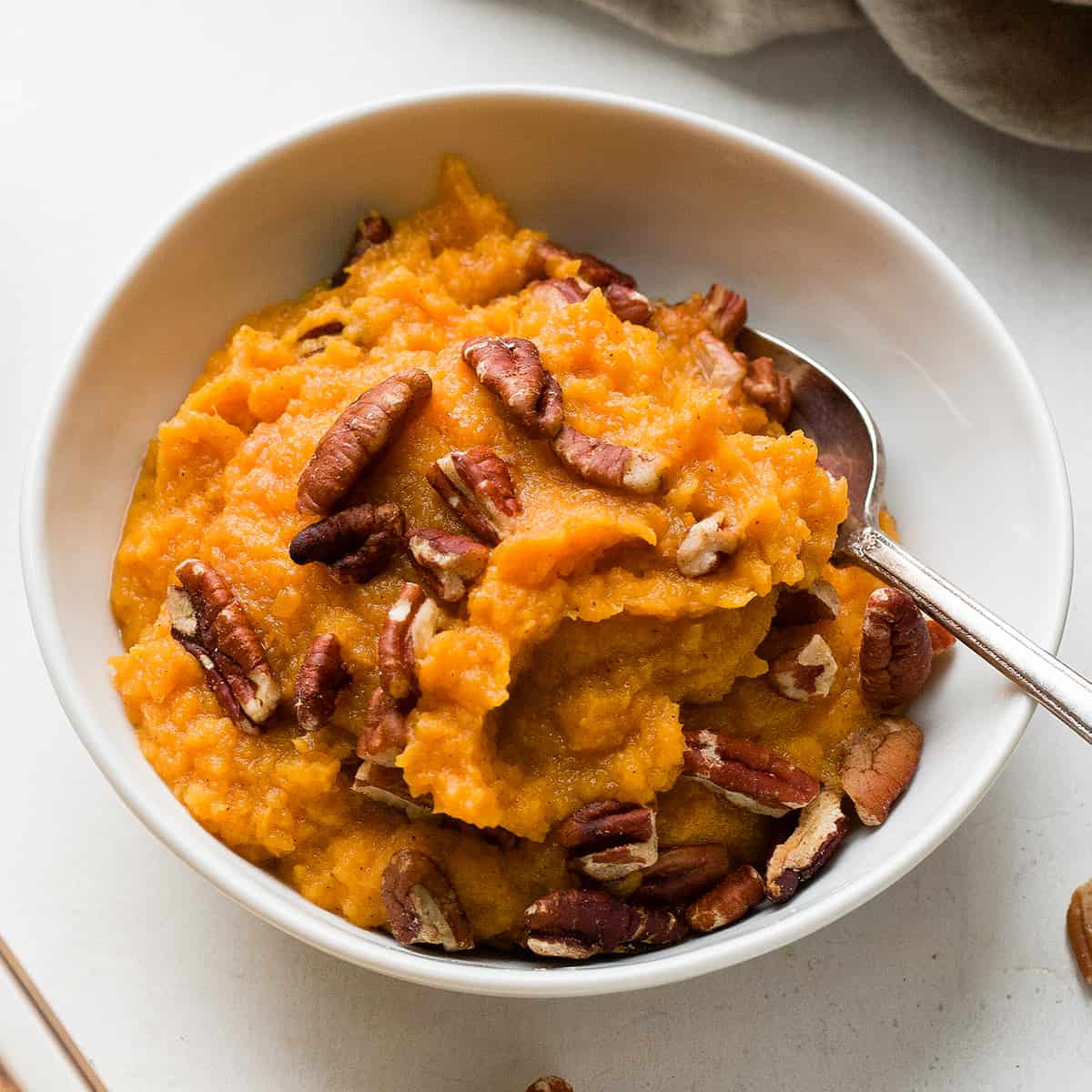 front view of Healthy Sweet Potato Casserole in a bowl with a spoon