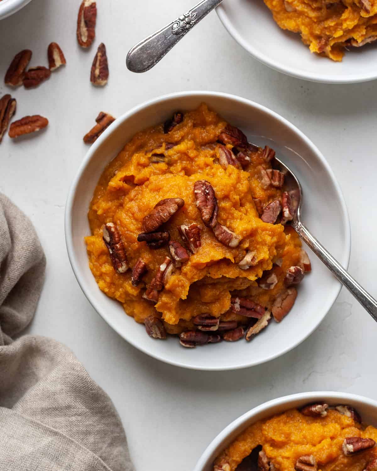 overhead view of Healthy Sweet Potato Casserole in a bowl with a spoon