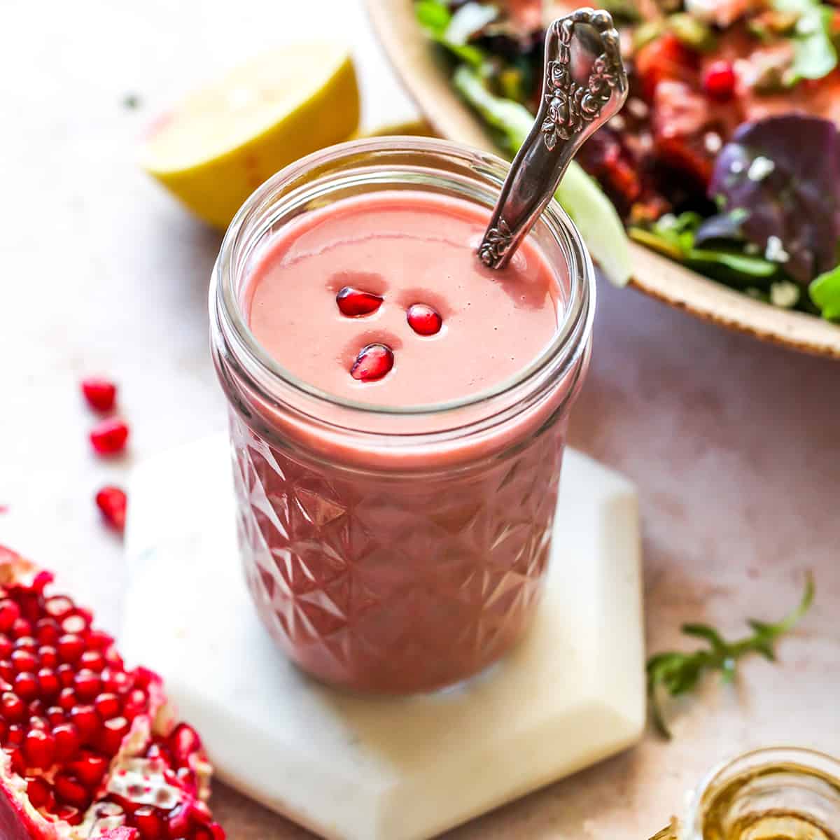 front view of a jar of pomegranate dressing