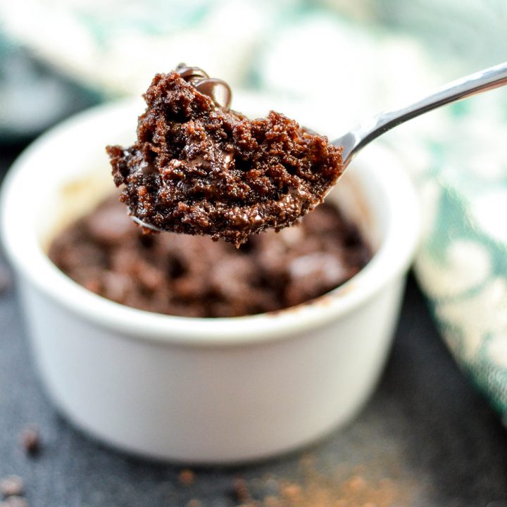 Up-close, front view of a spoon with a bite of healthy mug brownie on it