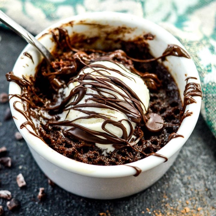 healthy mug Brownie with paleo vanilla ice cream and a chocolate drizzle in a white ramekin