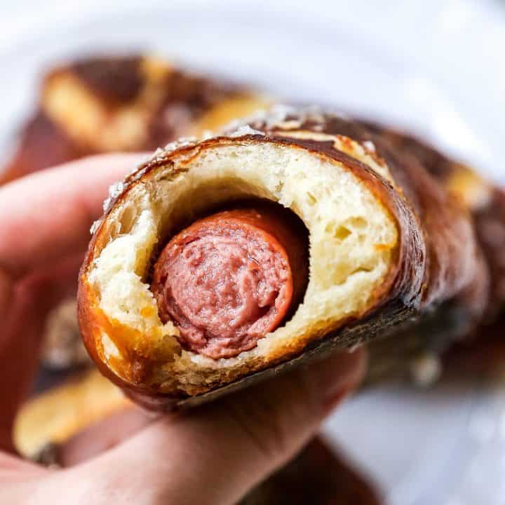 pretzel dog with a bite taken out of it so you can see inside