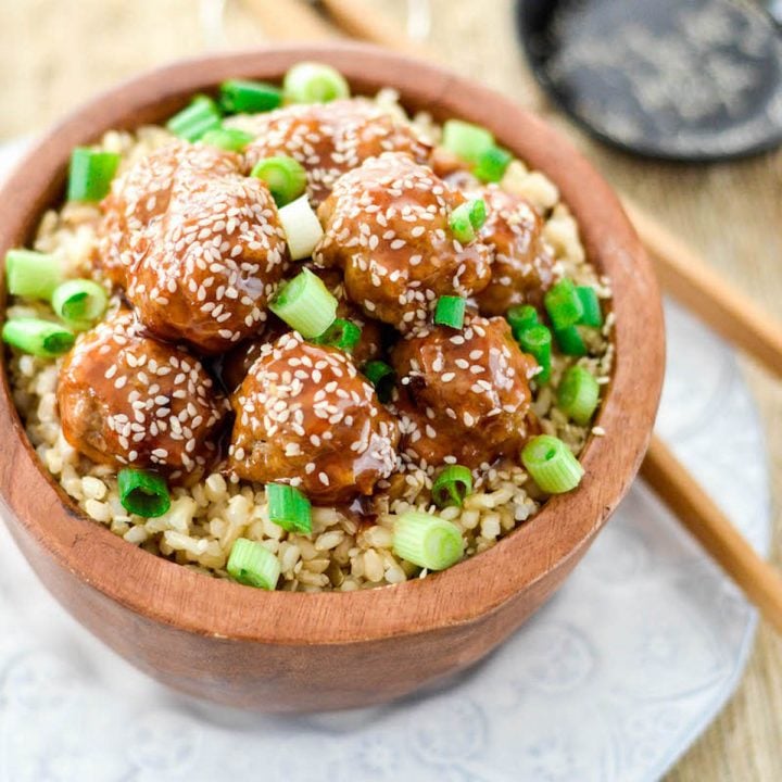 front view of Paleo Sweet and Sour Meatballs in a bowl over rice