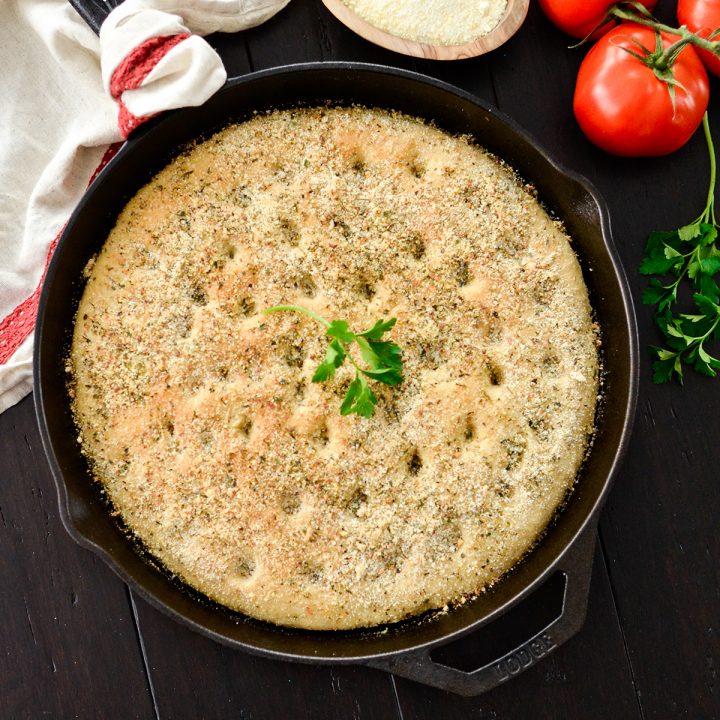 overhead photo of Whole Wheat Focaccia Bread baked in a cast iron skilelt