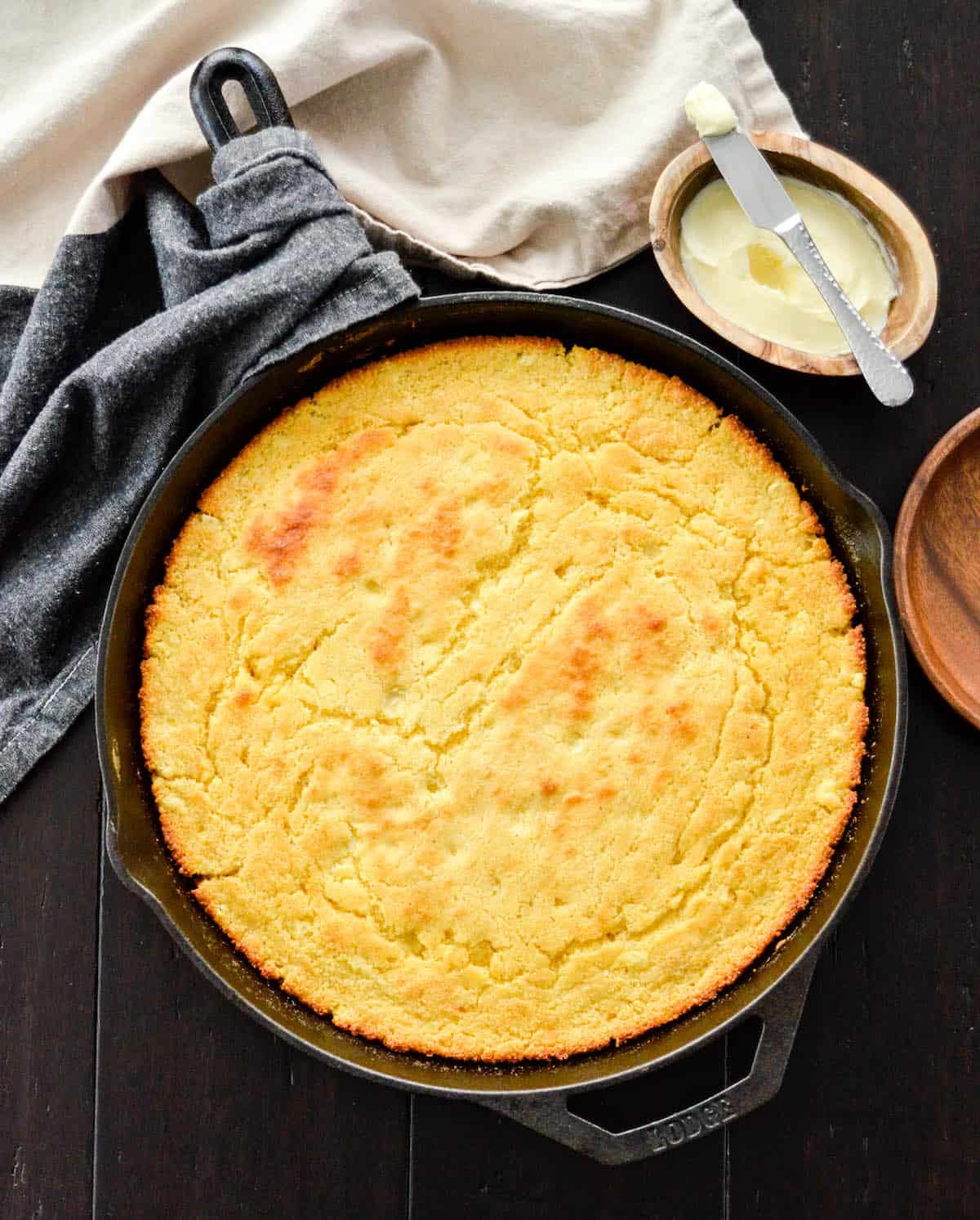 skillet cornbread baked in a black cast iron skillet before cutting