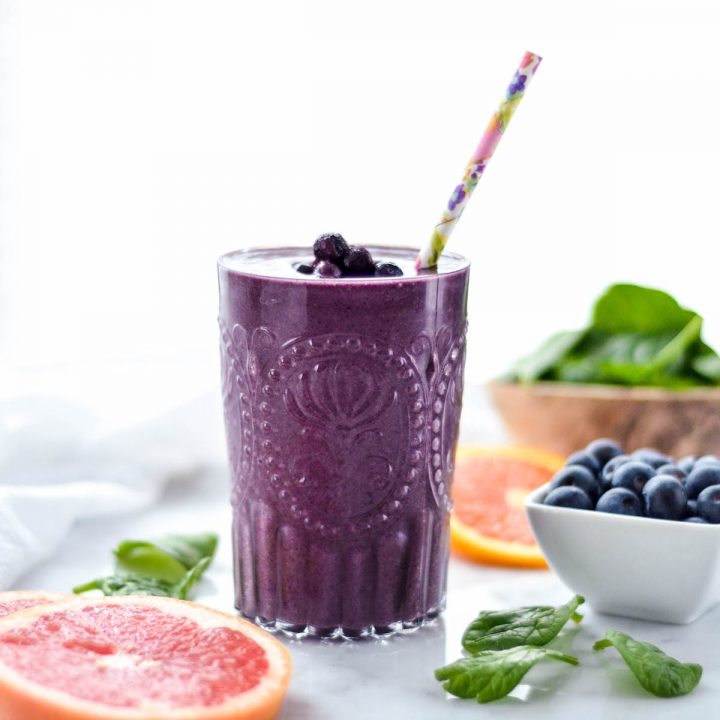 Front view of a glass of Blueberry Citrus Smoothie with Spinach