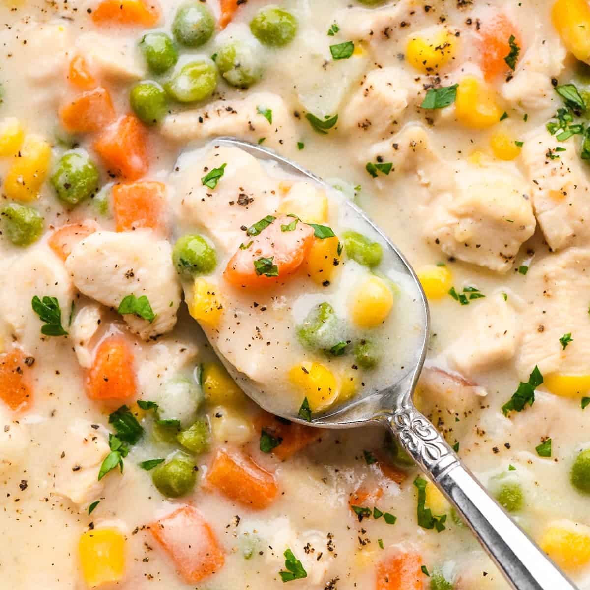 up close photo of a spoon taking a scoop of Chicken Pot Pie Soup