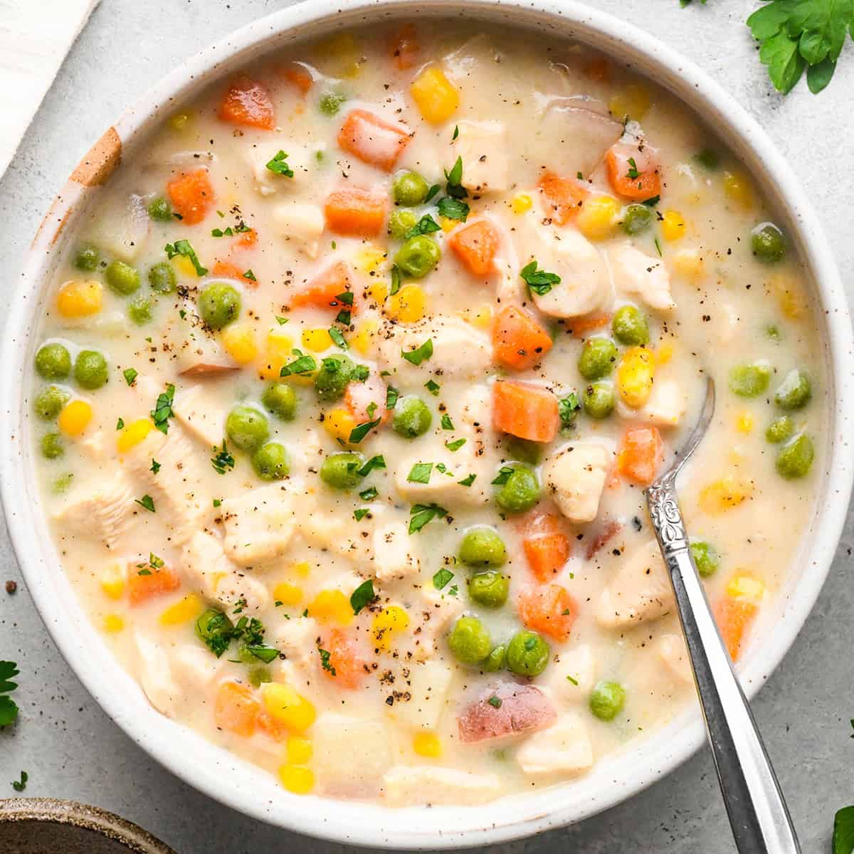 a bowl of chicken pot pie soup with a spoon