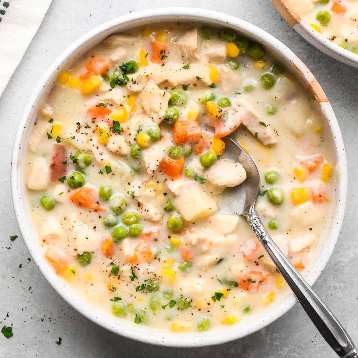 Chicken Pot Pie Soup in a bowl with a spoon