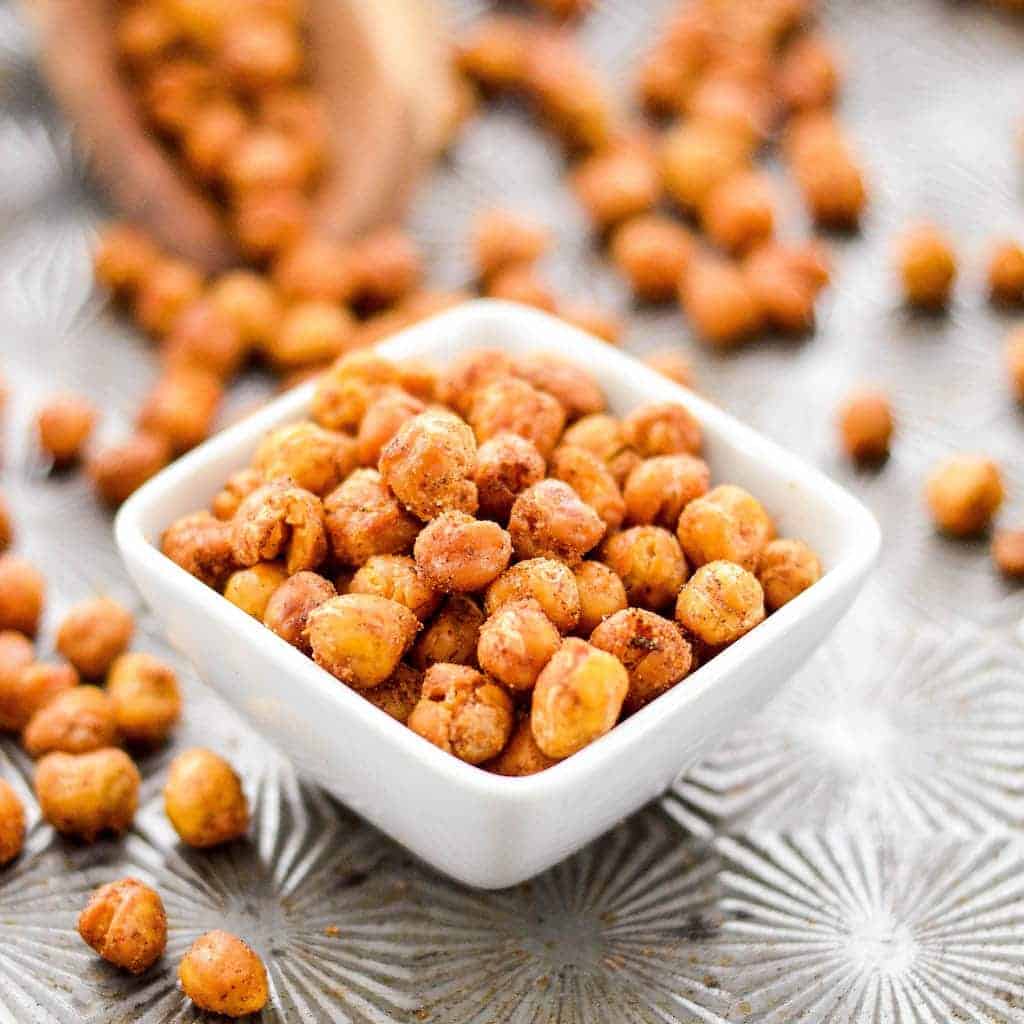 Side, close up shot of a small square dish full of crunchy roasted chickpeas 
