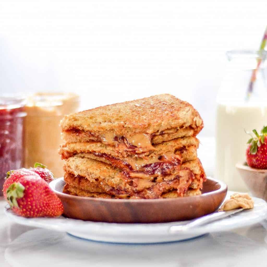 front view of a stack of four Grilled Peanut Butter and Jelly Sandwich Recipe halves 