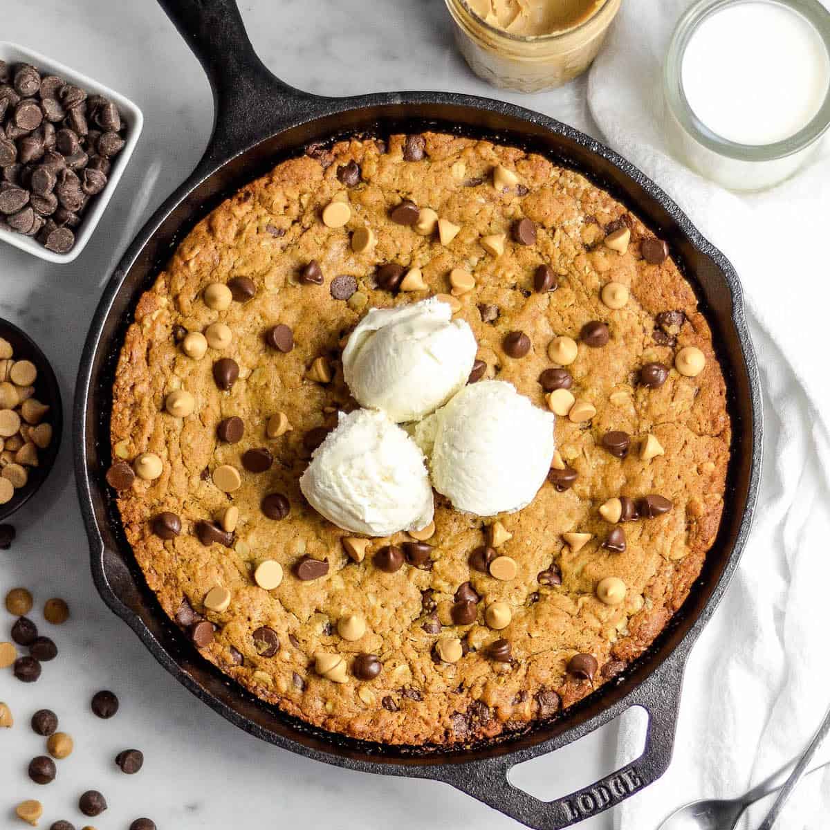 Skillet Peanut Butter Cookie in a cast iron skillet with 3 scoops of ice cream