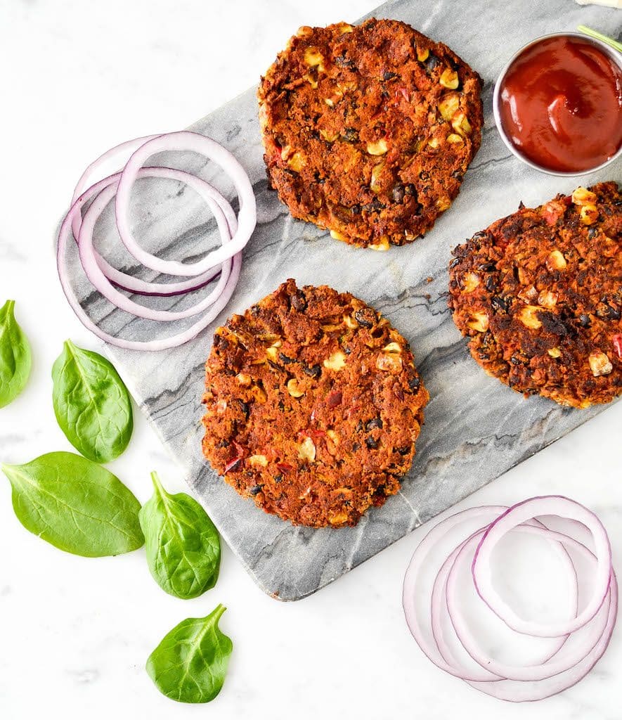  Overhead view of Black Bean Sweet Potato Burger patties on a marble cutting board