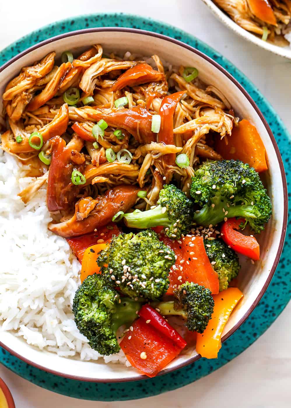 overhead view of a bowl of crockpot teriyaki chicken with veggies and rice