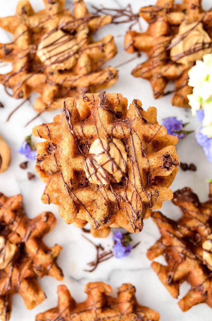 Overhead view of a stack of peanut butter waffles surrounded by four other waffles