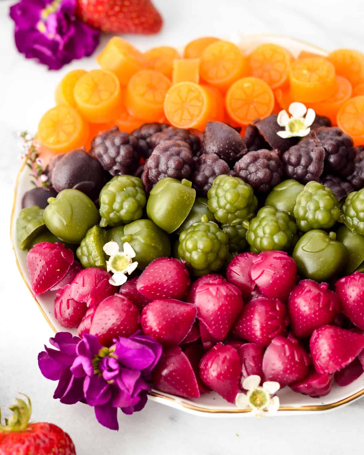 homemade fruit snacks on a plate arranged in colors