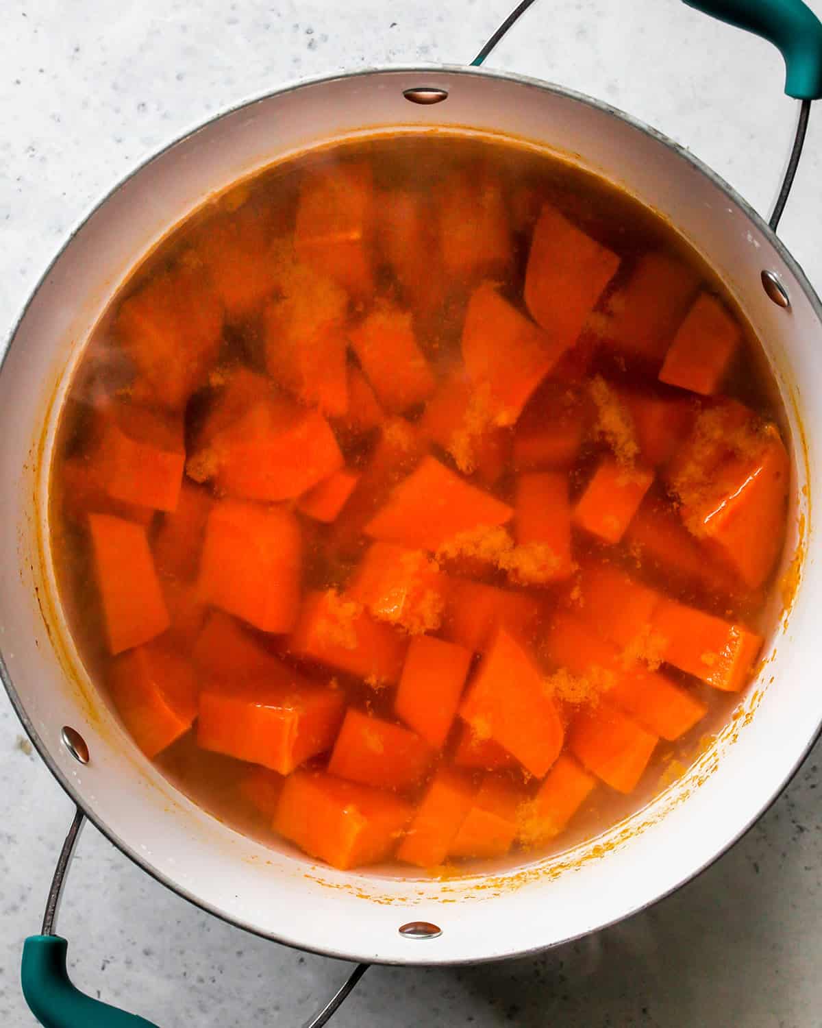 How to Make Sweet Potato Baby Food - sweet potatoes boiling in a pot of water