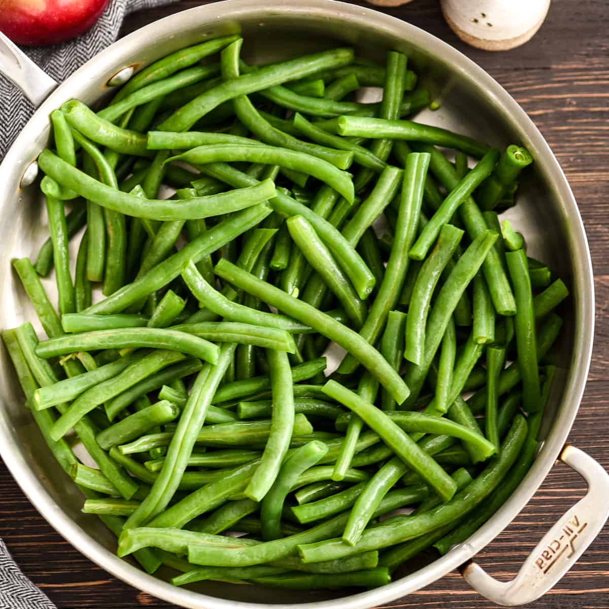 Overhead view of Sautéed Green Beans Recipe in a frying pan before cooking