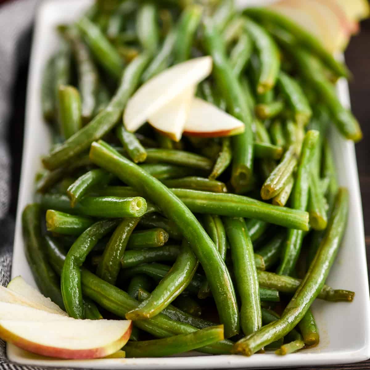 front view of a serving dish of Sautéed Green Beans Recipe with Apple Cider