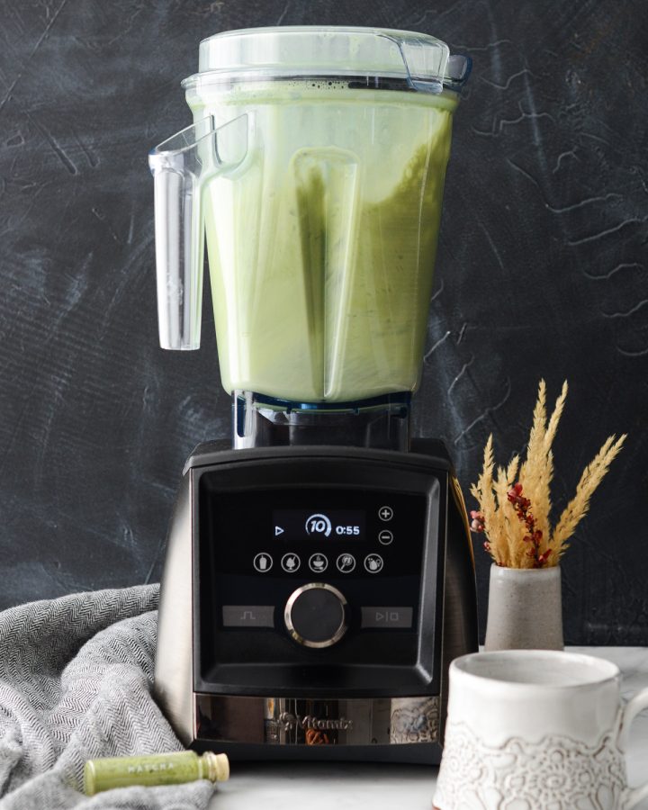 Front view of Collagen Matcha Latte mixing in a vitamix blender