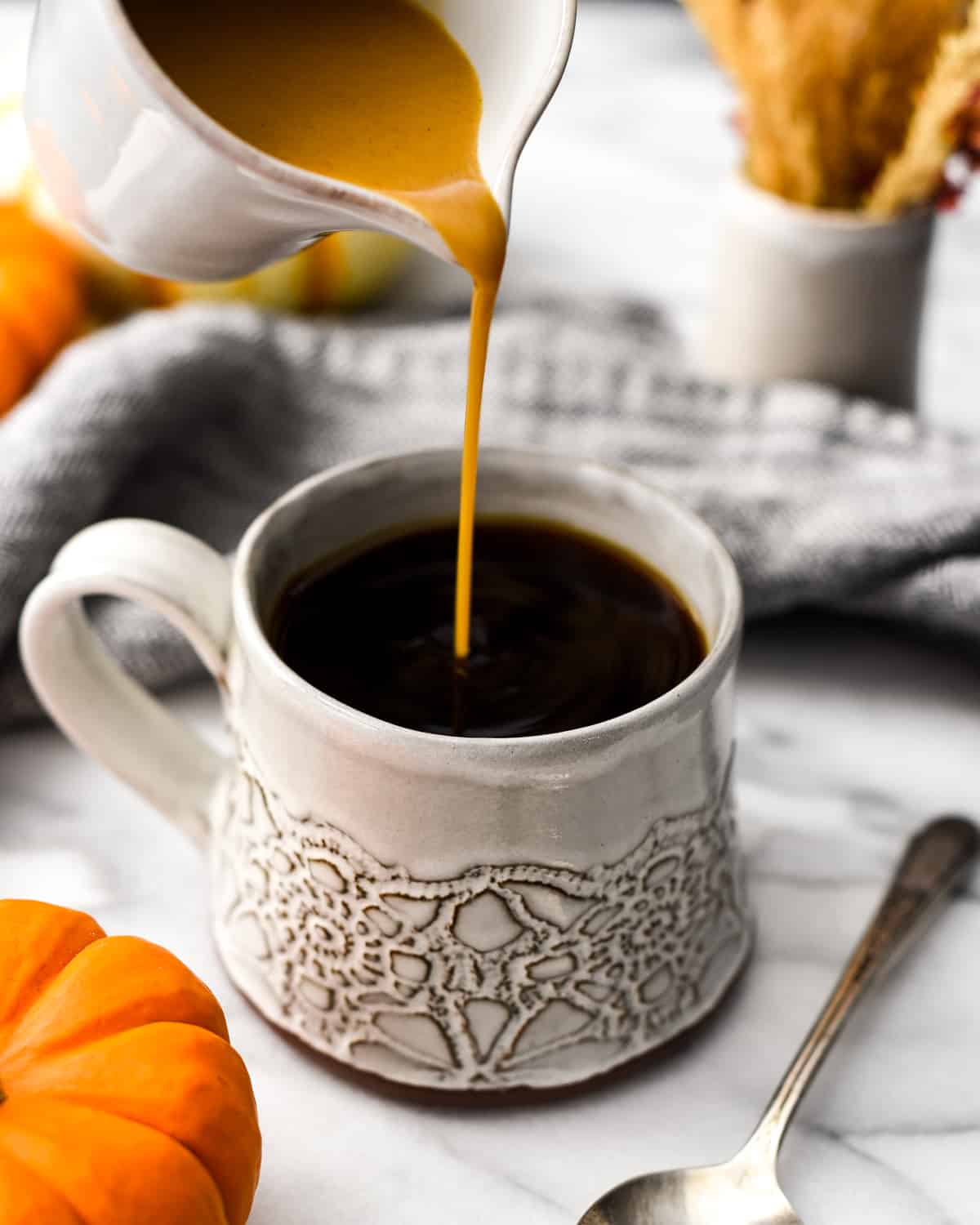 Front shot of Pumpkin Coffee Creamer being poured into a mug of coffee