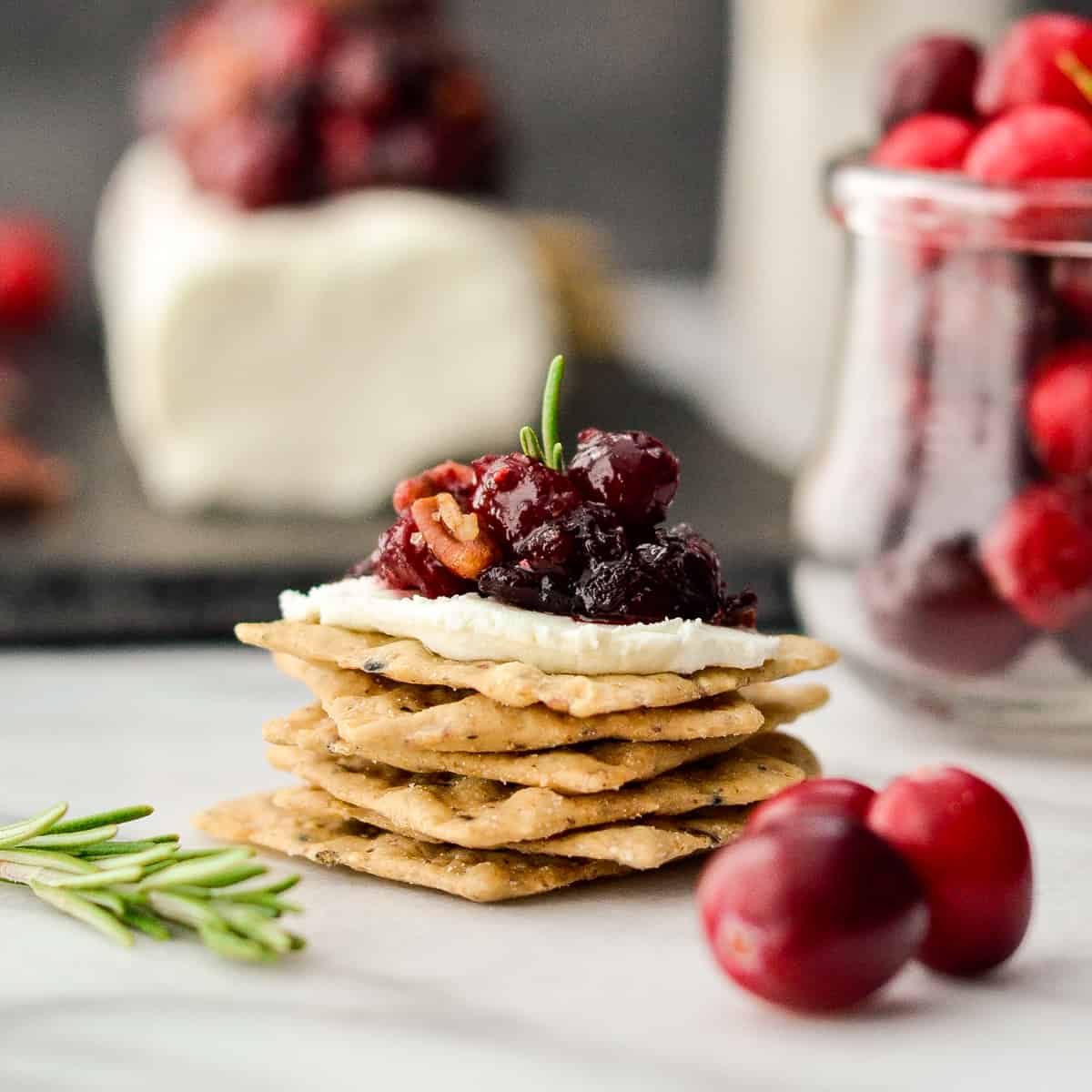 Cranberry Goat Cheese Appetizer on top of a stack of crackers