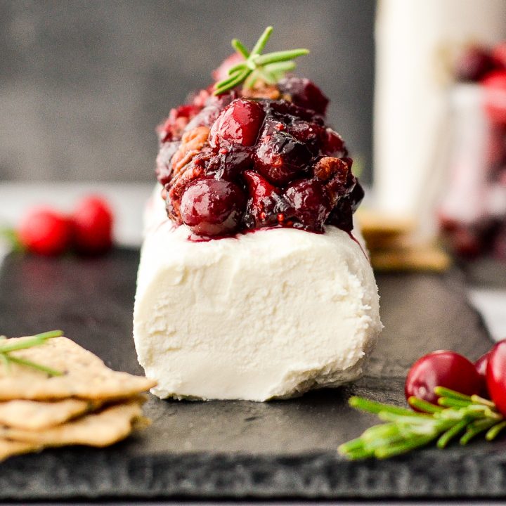 Cranberry Goat Cheese Appetizer on a serving plate garnished with rosemary
