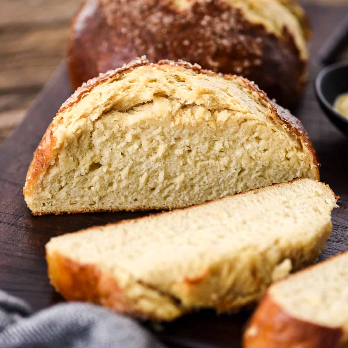 a loaf of pretzel bread with two slices cut out of it