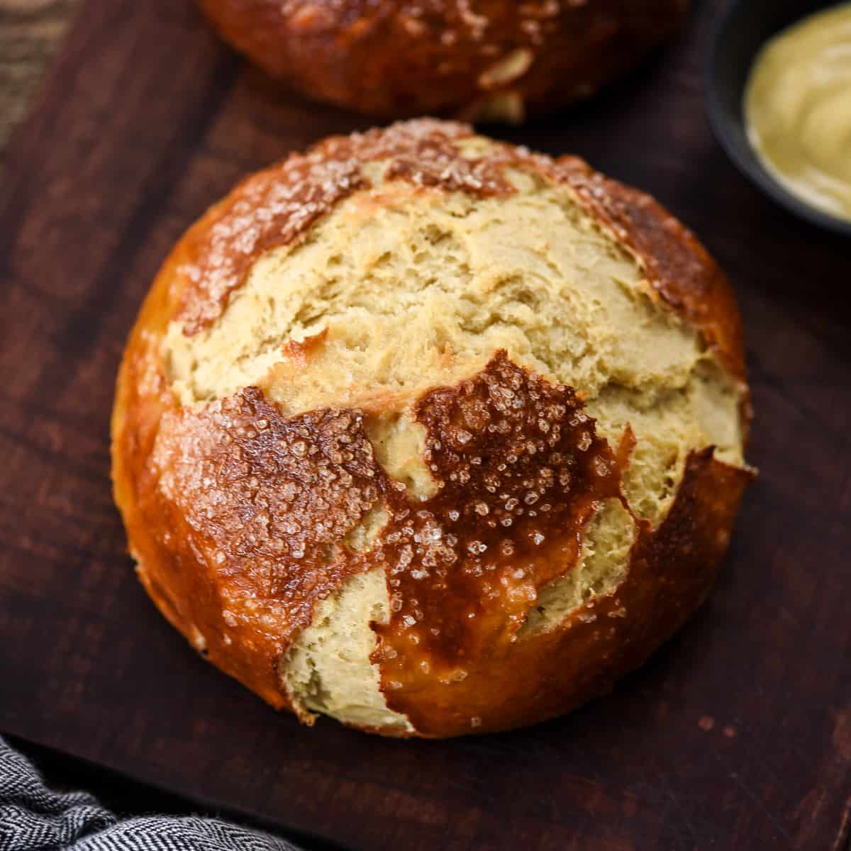 a loaf of pretzel bread on a cutting board