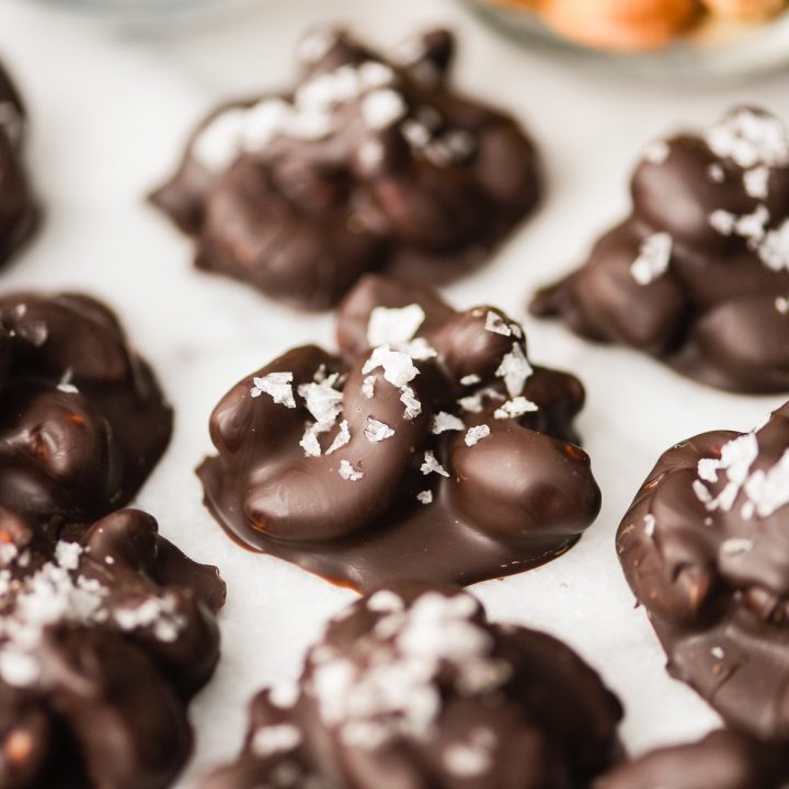 up close photo of a cluster of Chocolate Covered Cashews with sea salt on top 