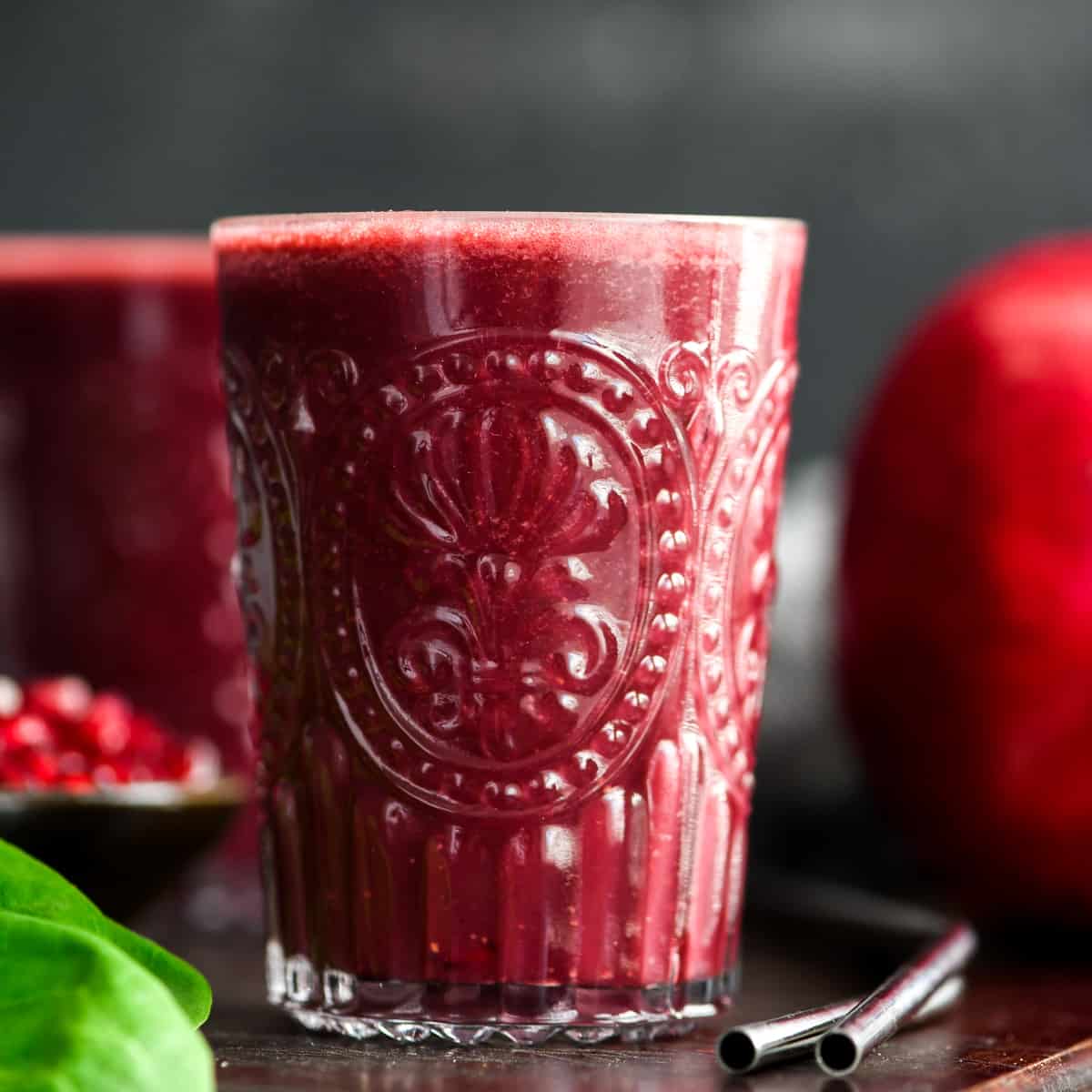 a glass filled with Beet & Pomegranate Smoothie with Spinach 