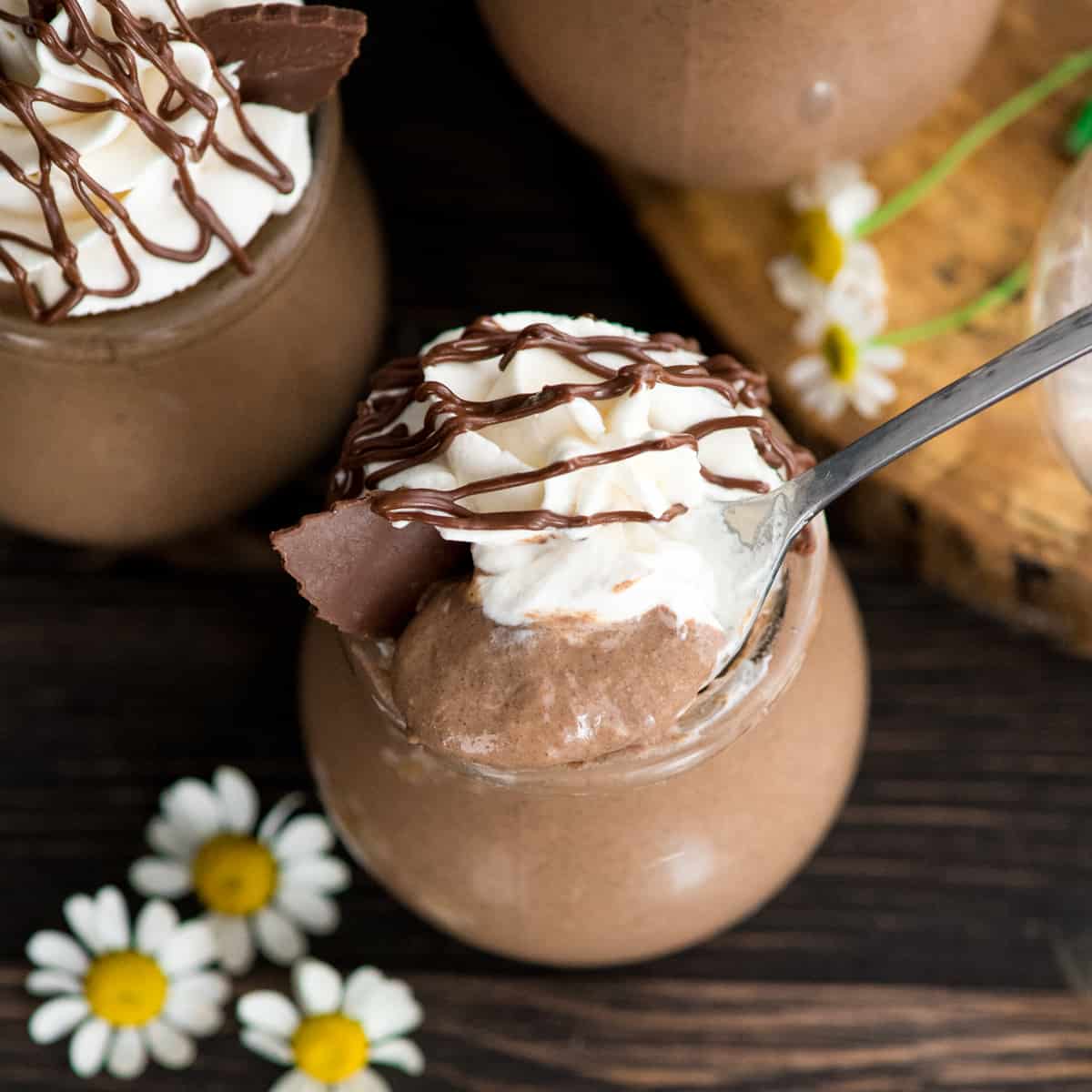 a spoon taking a bite of Creamy Chocolate Peanut Butter Chia Pudding out of a jar 