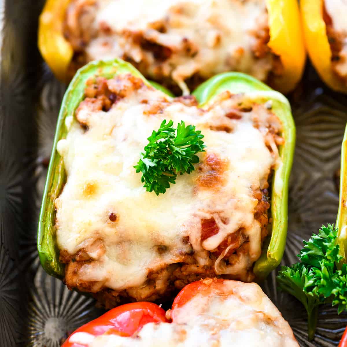 Healthy Italian Stuffed Peppers on a baking pan with parsley on top